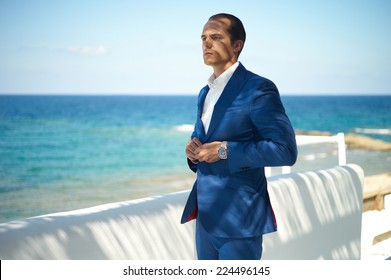 Fashion Portrait Of A Handsome Man In Blue Suit