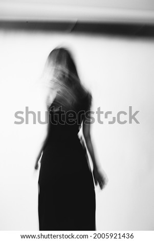 fashion portrait on a white background, art smeared photo, soft focus of body movement