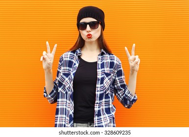 Fashion Portrait Pretty Cool Girl Wearing A Black Hat, Sunglasses And Shirt Over Colorful Background