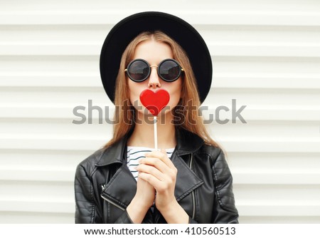 Fashion portrait pretty sweet young woman having fun with lollipop over white background