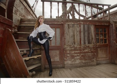 Fashion portrait of sexy woman in pirate style with old handgun