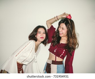 Fashion Portrait Of Two Young Asian Hipster Women Wearing Bohemian Outfit Smiling - Retro Vintage Film Filter Effect With Some Fine Film Grain Added 