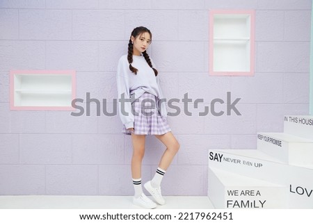 Fashion portrait of a young Asian woman in sporty fashion