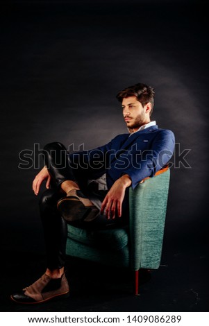 Similar – Young man with lost look in a modern pub.