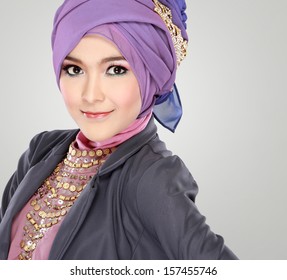 Fashion portrait of young beautiful muslim woman with purple costume wearing hijab