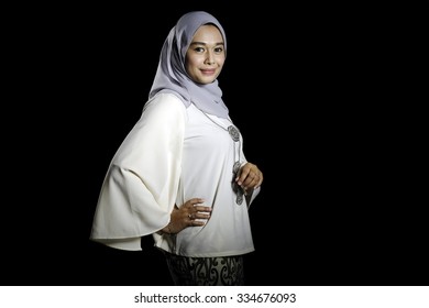 Fashion portrait of young beautiful muslim woman with modern kebaya with hijab isolated on black background