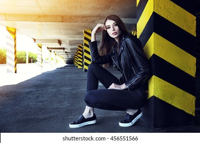 Fashion Portrait Of Young Elegant Woman Outdoor In Black Leather Jacket, Jeans, Slip-on Shoes. Urban Street Style