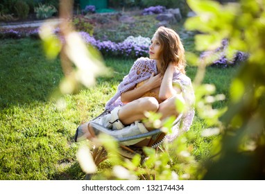 Fashion Portrait Of Young Sensual Woman In Garden  Sitting In The Chair