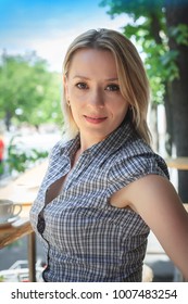 Fashion Portrait Of Young Woman Sitting Street Cafe. Street Fashion, Smiling, Happy, Blonde, Harmony. Authentic. Closeup Portrait