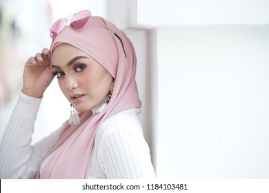 Fashion portraiture of young beautiful muslim woman wearing hijab. Image contain certain grain or noise and soft focus. - Powered by Shutterstock