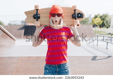 Fashion pretty cool girl with skateboard on skate park background
