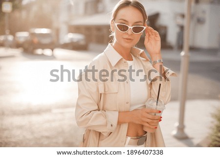 fashion pretty woman with coffee at the street 