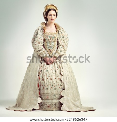 Fashion, royal and victorian queen in studio with a renaissance, luxury and fancy dress. Royalty, beauty and medieval woman ruler with elegant, vintage and regal costume isolated by white background.