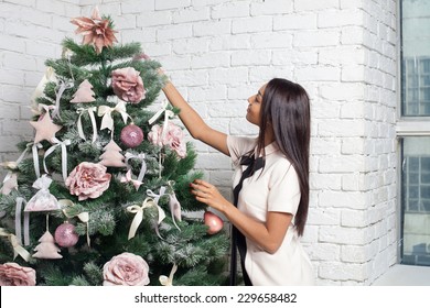 Fashion And Sexy African Woman Decorating Christmas Tree