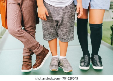 Fashion Shoes On Kids. Three Pairs Of Children's Feet Wearing Comfortable And Fashion Trainers. Back To School Concept