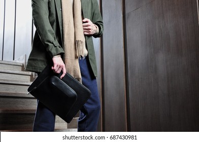 man with clutch bag