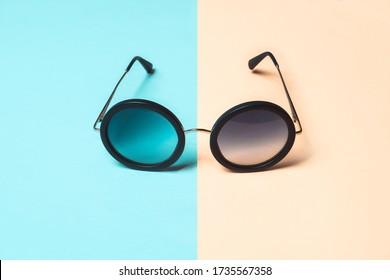 Fashion shot, round sunglasses on pastel blue and coral background. Minimal summer concept. - Powered by Shutterstock