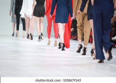 Fashion Show, Catwalk Runway Show Event. Detail Of Lined Up Rear View Fashion Models Legs With High Heels.