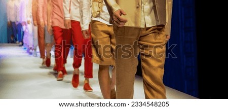 Fashion show with male models on the stage