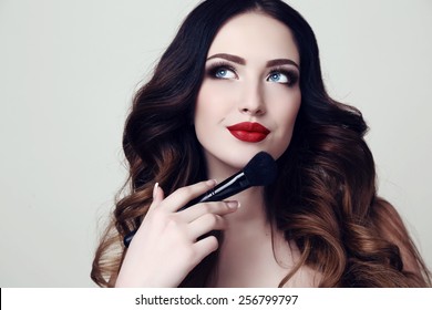 Fashion Studio Photo Of Beautiful Sensual Woman With Dark Hair And Bright Makeup, Holding Makeup Brush In Hand