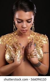 Fashion Studio Photo Of Gorgeous Sexy Woman With Dark Hair Posing Nude, With Body Art Gold Painting 