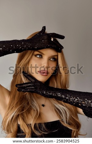 fashion studio photo of gorgeous woman with blond hair in elegant clothes and accessories in black gloves