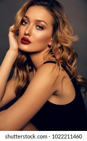 Fashion Studio Portrait Of Beautiful Girl With Blond Curly Hair And Evening Makeup