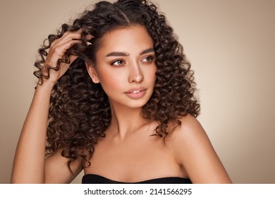 Fashion studio portrait of beautiful smiling woman with afro curls hairstyle. Fashion and beauty - Shutterstock ID 2141566295