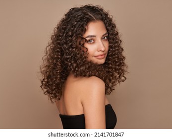 Fashion studio portrait of beautiful smiling woman with afro curls hairstyle. Fashion and beauty - Shutterstock ID 2141701847