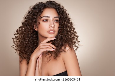 Fashion studio portrait of beautiful smiling woman with afro curls hairstyle. Fashion and beauty - Shutterstock ID 2165205481