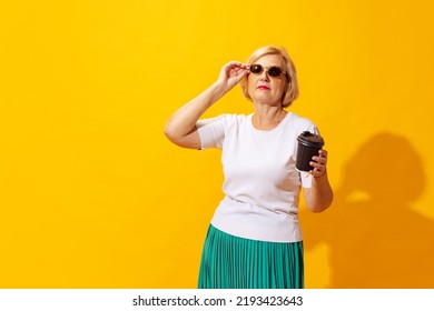 Fashion. Studio Shot Of Fashionable Senior Woman In Summer Style Outfit Isolated On Bright Yellow Background. Concept Of Beauty, Emotions, Vacation, Travel, Ad And Sales