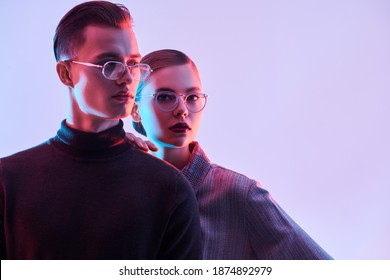 Fashion Studio Shot. Handsome Young Man And Beautiful Young Woman Posing Together In Stylish Glasses. Optics. Business Style.