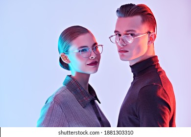 Fashion Studio Shot. Handsome Young Man And Beautiful Young Woman Posing Together In Stylish Glasses. Optics. Business Style.