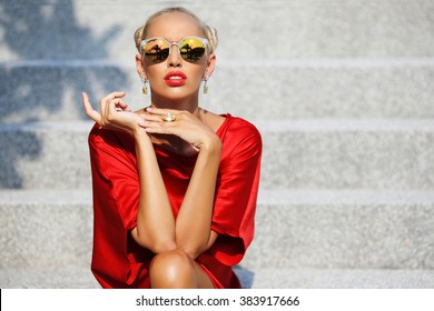 Fashion style portrait of attractive female model in sunglasses