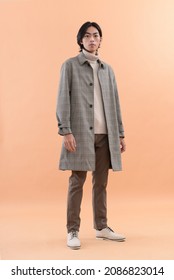 Fashion And Style.full Length Body Young Handsome Man Wearing Coat,sweater , Pants In Brown Background

