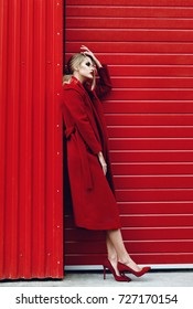 Fashion Stylish Woman Posing  In Red Dress Over Red Urban Background