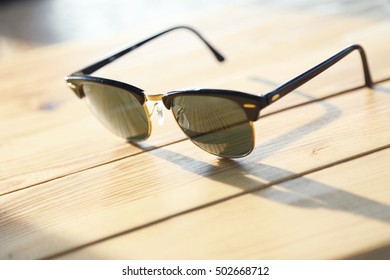 Fashion sunglasses on a wood table