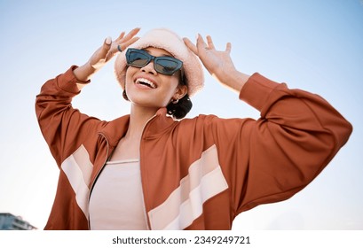 Fashion, sunglasses and smile with a trendy woman outdoor on a blue sky for freedom, energy or style. Portrait, summer and clothes with a happy young model in an urban outfit while on vacation - Shutterstock ID 2349249721