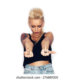 Fashion Swag Sexy Blonde Young Woman With Tattoo Showing Middle Finger. White Background, Not Isolated