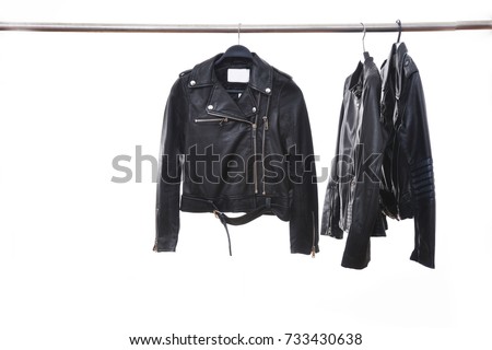 fashion three black leather punk jacket hanging isolated on hanger