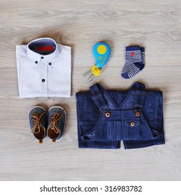 Fashion Trendy Look Of Baby Clothes And Toy On The Wooden Floor. Little Gentleman Boy Flat Lay Apparel Items Set. Cute And Stylish Children Background Collage.