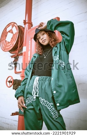 Fashion, wall and black woman with green clothes, fashionable style or cool hip hop outfit. Fire hose, attitude or portrait of gen z girl with trendy streetwear, designer brand or 2000s rap aesthetic