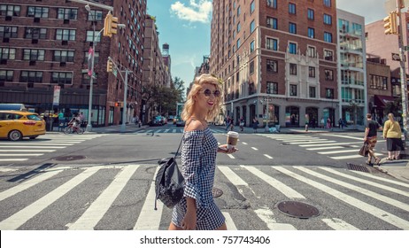 Fashion Woman Crossing The Street In New York, With A Cup Of Coffee