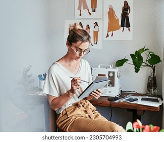 Fashion, woman and designer with a tablet, workshop and typing with startup success, planning and update schedule. Female person, worker and entrepreneur with technology, creative and search website - Powered by Shutterstock