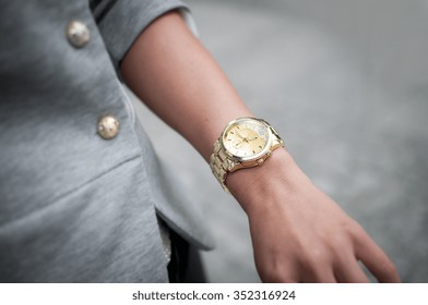 Fashion Woman With Golden Watch On Hand