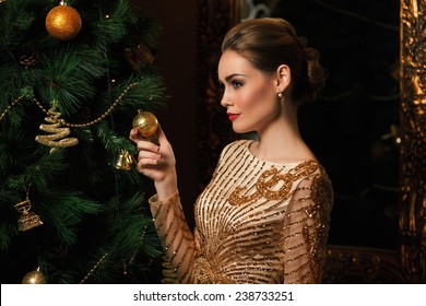 Fashion Woman Hanged A  On The Christmas Tree, Stylized As Gold