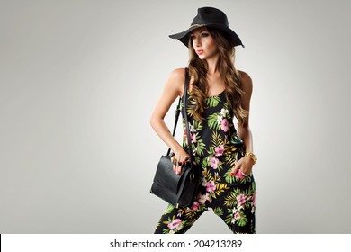 Fashion Woman Holding Handbags Wearing Jumpsuit, Hat, Wedges Shoes. Studio Shot