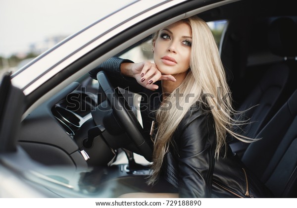 fashion\
woman in luxury car. young blonde girl\
portrait