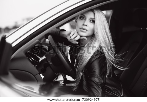 fashion\
woman in luxury car. young blonde girl\
portrait