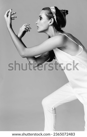 Fashion woman model editorial posing in the studio